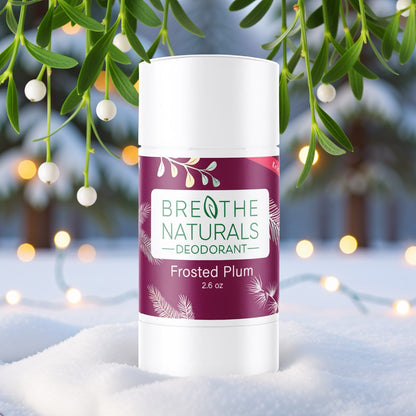 Breathe Naturals Frosted Plum deodorant stick with mistletoe and lights in the background