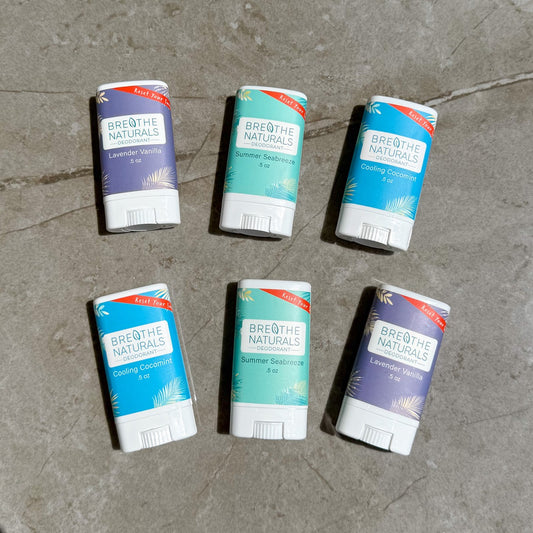 Six containers of Breathe Naturals products on a concrete surface